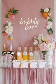 A pink backdrop with flowers and a bubble bar.