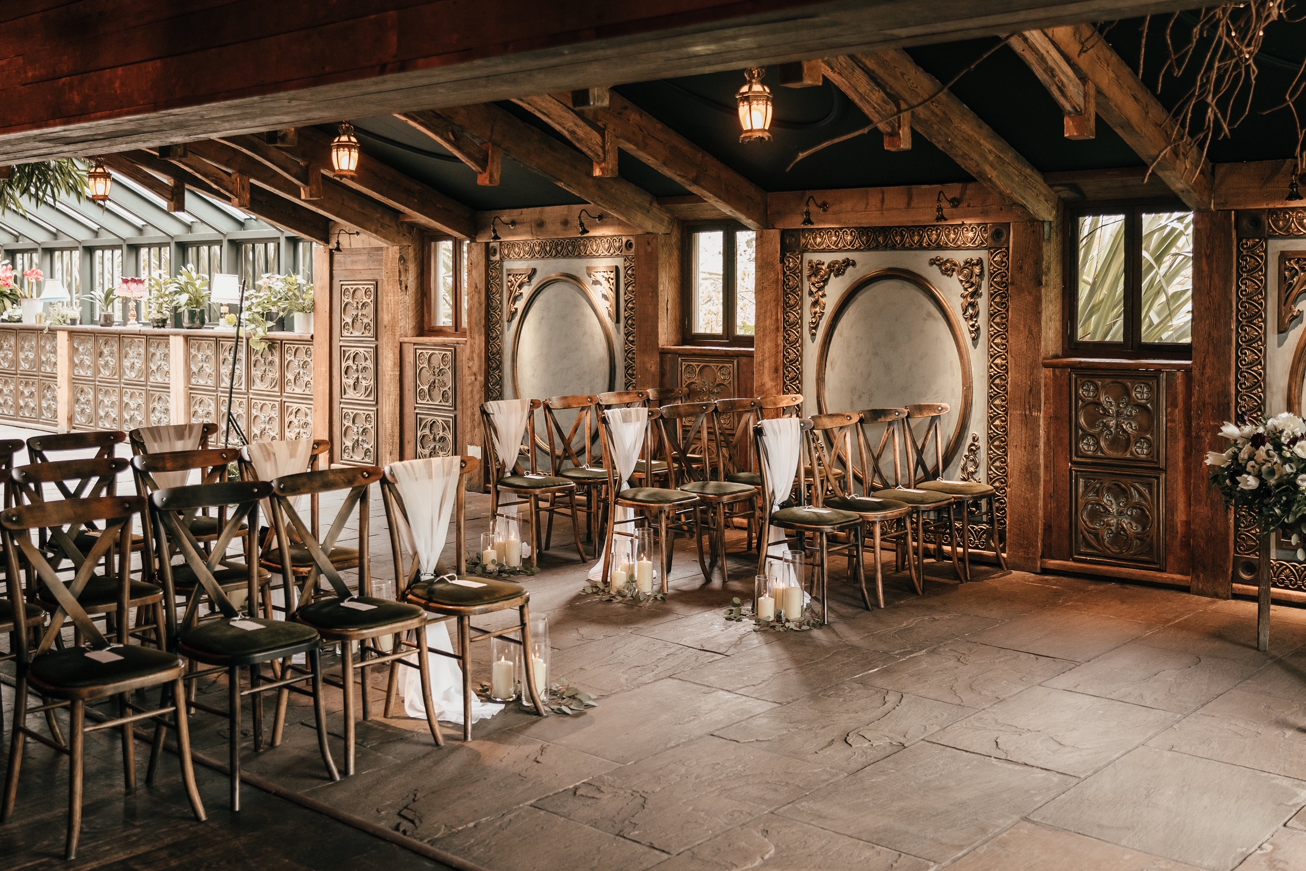 Newton Hall in Northumberland dressed for a wedding ceremony with chair sashes and aisle candles and beautiful wedding flowers.